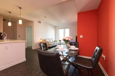 a kitchen and dining room with a table and chairs at Modern Apartment Rentals in Los Angeles