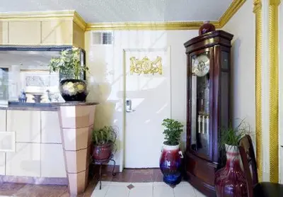 a room with a door and some vases and a clock at Americas Best Value Inn & Suites - Fontana in Fontana