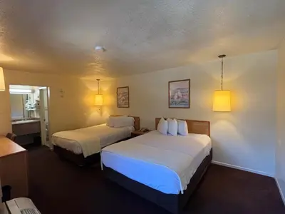 a hotel room with two beds and a bathroom at Premier Inns Thousand Oaks in Thousand Oaks