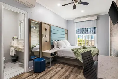 a small bedroom with a bed and a bathroom at Lumea by the Sea Long Beach Convention Center in Long Beach