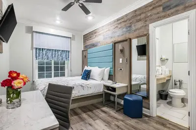 a bedroom with a bed and a bathroom at Lumea by the Sea Long Beach Convention Center in Long Beach