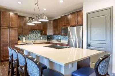 a kitchen with a large island in a kitchen with wooden cabinets at Bluegreen Vacations Big Bear Village, an Ascend Collection Resort in Big Bear Lake