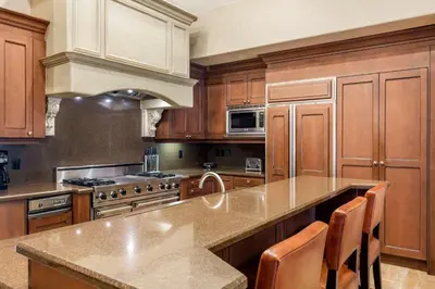 a large kitchen with wooden cabinets and a counter top at Bluegreen Vacations Big Bear Village, an Ascend Collection Resort in Big Bear Lake