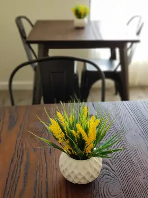 a vase with yellow flowers sitting on a table at Anchor Pointe Inn in Wilmington