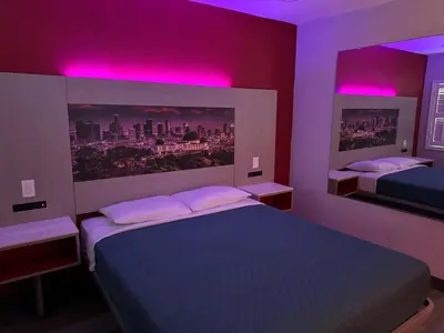 a bedroom with two beds and purple lights at Lincoln Motel - Los Angeles, Hollywood Area in Pasadena