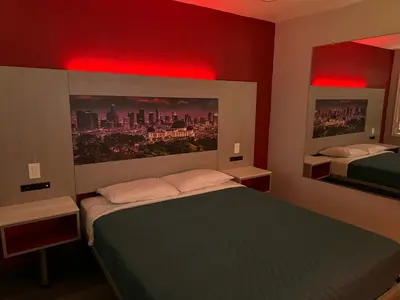a bedroom with two beds and red lights at Lincoln Motel - Los Angeles, Hollywood Area in Pasadena