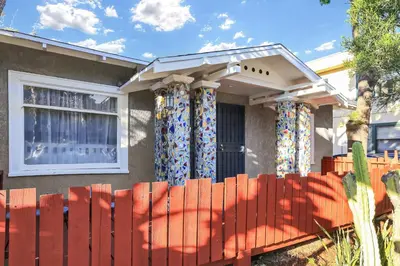 a house with a red fence in front of a window at Long Beach House in Long Beach