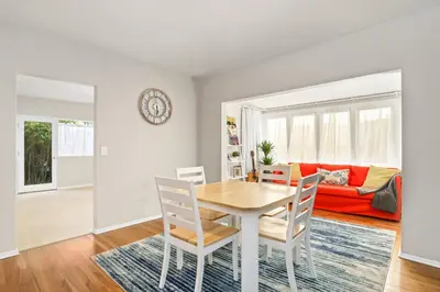 a dining room and living room with a table and chairs at Long Beach House in Long Beach