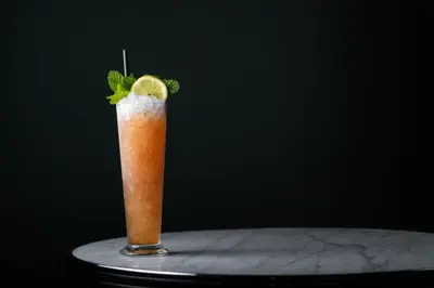 a drink with a lemon and mint on a table at Palihotel Culver City in Los Angeles