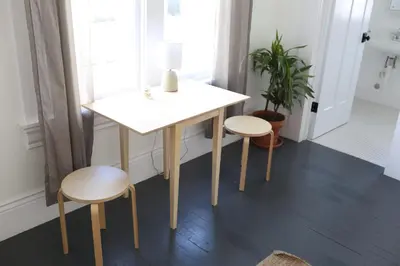 a table and two stools sitting next to a table at The Burlington in Los Angeles