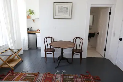 a table and two chairs in a living room at The Burlington in Los Angeles
