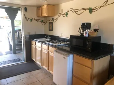 a kitchen with a sink and a microwave and a counter at Fireside Lodge in Big Bear Lake