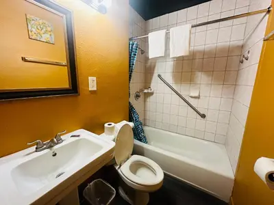 a bathroom with a sink and a toilet and a bath tub at Casa Blanca Inn - Whittier, Los Angeles in Whittier