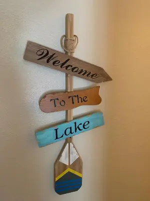 a sign that says welcome to the lake and to the lighthouse at The North Shore Inn in Crestline