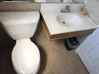 a bathroom with a white toilet and a sink at Whittier Travel Inn in Whittier