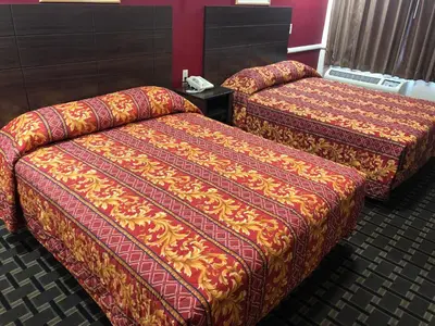 two beds sitting next to each other in a room at Whittier Travel Inn in Whittier