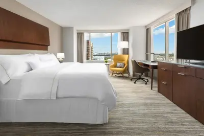 a hotel room with a bed and a desk with a computer at The Westin Long Beach in Long Beach