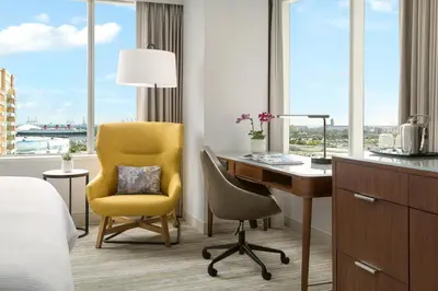 a hotel room with a desk and a chair and a desk and window at The Westin Long Beach in Long Beach