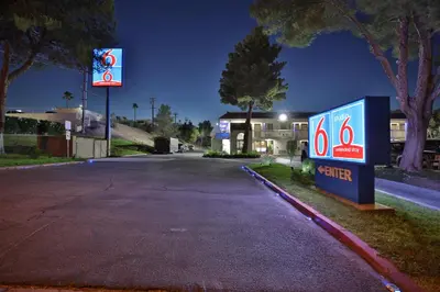 an empty street with a gas station at night at Studio 6-Barstow, CA in Barstow