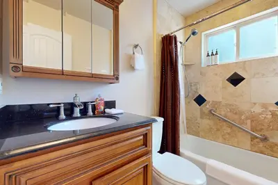 a bathroom with a sink and a toilet and a shower at Dancing Bear Chalet in Lake Arrowhead