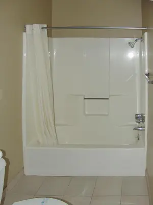 a bathroom with a shower with a shower curtain at Holland Inn and Suites in Taft