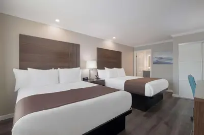 a hotel room with two beds and a window at SureStay Plus Hotel by Best Western Upland - Ontario North in Upland