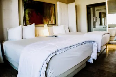a couple of beds in a hotel room at Devonshire Inn Motel in Rosamond