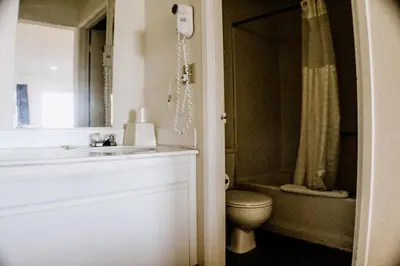 a bathroom with a sink and a toilet at Devonshire Inn Motel in Rosamond