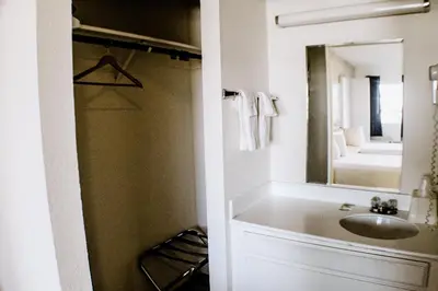a bathroom with a sink and a mirror at Devonshire Inn Motel in Rosamond