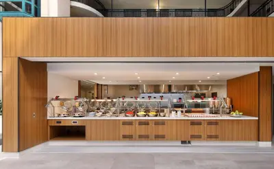 a large kitchen with a counter in a building at Embassy Suites by Hilton Anaheim North in Anaheim