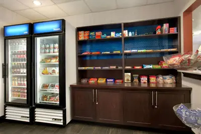 a kitchen with two refrigerators with food inside of it at Hampton Inn & Suites Anaheim Garden Grove in Anaheim