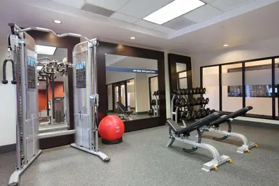 a gym with two tread machines and a red ball at Hampton Inn & Suites Anaheim Garden Grove in Anaheim