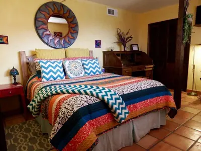 a bedroom with a bed and a mirror on the wall at Ocean View Casita in Los Angeles