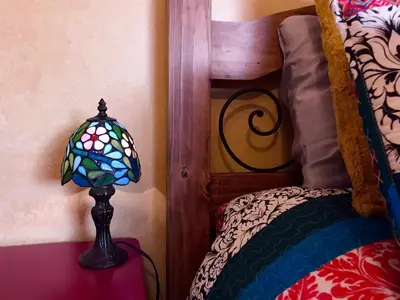 a lamp sitting on a table next to a bed at Ocean View Casita in Los Angeles