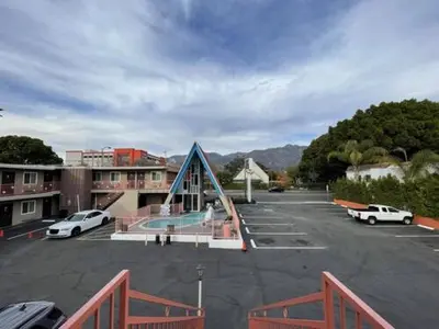 a parking lot with cars parked in a parking lot at La Casa Inn in Pasadena