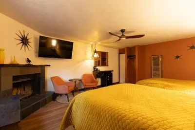 a hotel room with a bed and a fireplace at The Burgundy in Big Bear Lake
