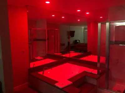 a red bathroom with a tub with red lighting at Economy Inn near Ontario Airport - Chino in Ontario