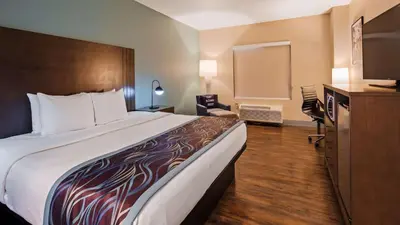 a hotel room with a large bed and a television at Best Western Plus New Barstow Inn & Suites in Barstow