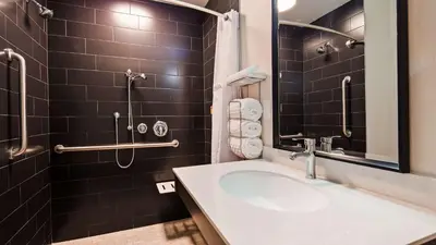 a bathroom with a sink and a shower at Best Western Plus New Barstow Inn & Suites in Barstow
