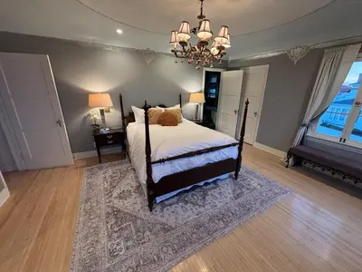 a bedroom with a bed and a chandelier at SpanishFairytale4bd3ba in San Pedro