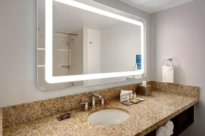 a bathroom with a sink and a large mirror at DoubleTree by Hilton LAX - El Segundo in El Segundo