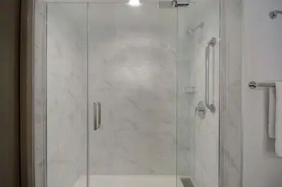 a shower with a glass door in a bathroom at DoubleTree by Hilton LAX - El Segundo in El Segundo
