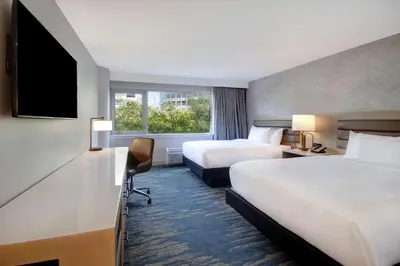 a hotel room with two beds and a television at DoubleTree by Hilton LAX - El Segundo in El Segundo