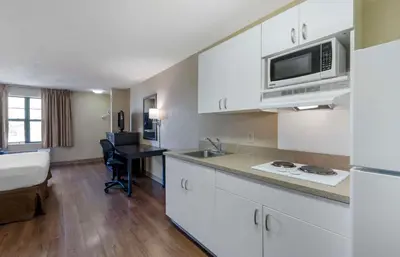 a kitchen with a bed and a desk in a room at Extended Stay America Suites - Orange County - Katella Ave in Orange