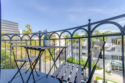 a balcony with a table and two chairs at Designer Penthouse 2 Bedroom with Balcony Beverly Hills Adjacent in Los Angeles