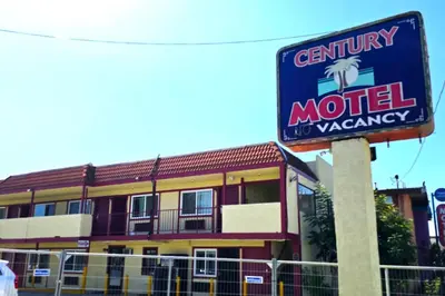 a sign for a motel in front of a building at Century Motel Buena Park Anaheim I-5 in Buena Park