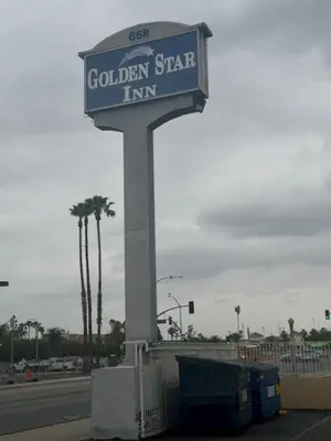 a sign for a golden star inn on a street at Golden Star Inn in San Bernardino