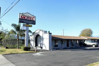 a motel sign in front of a building at Palm Inn Motel - Montclair in Montclair