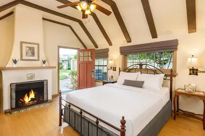 a bedroom with a bed and a fireplace at The Pierpont Inn in Ventura