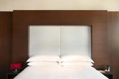 a bed with white pillows and a wooden headboard at Andaz West Hollywood, By Hyatt in Los Angeles